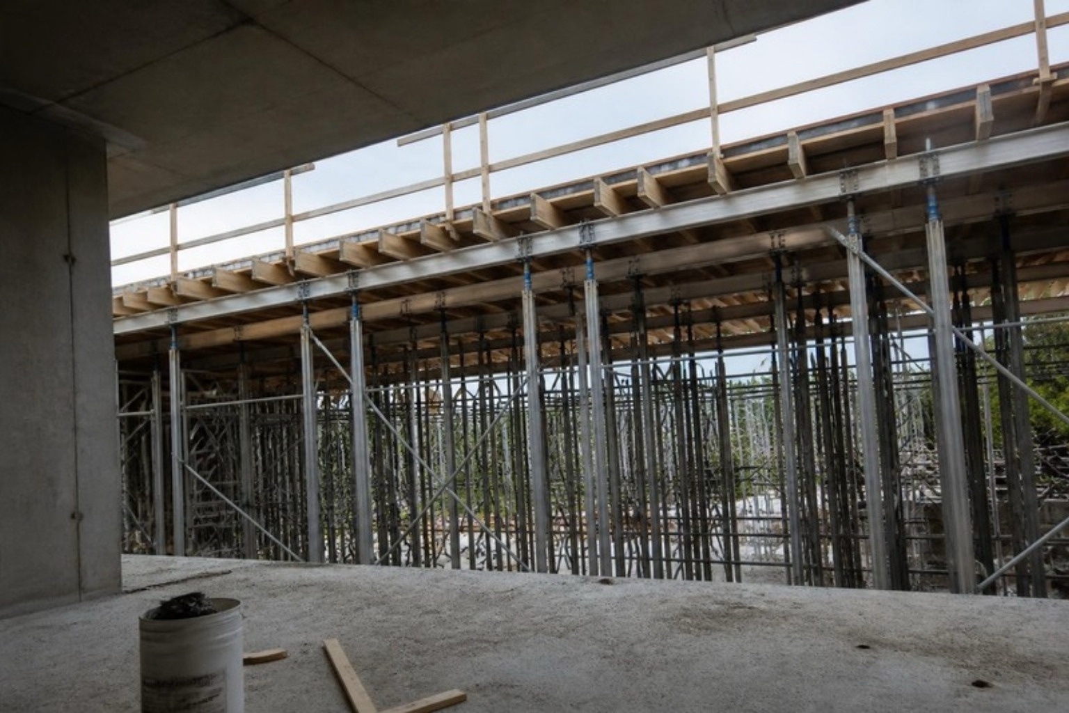 Shoring frames and beams holding up the formwork for the next suspended slab